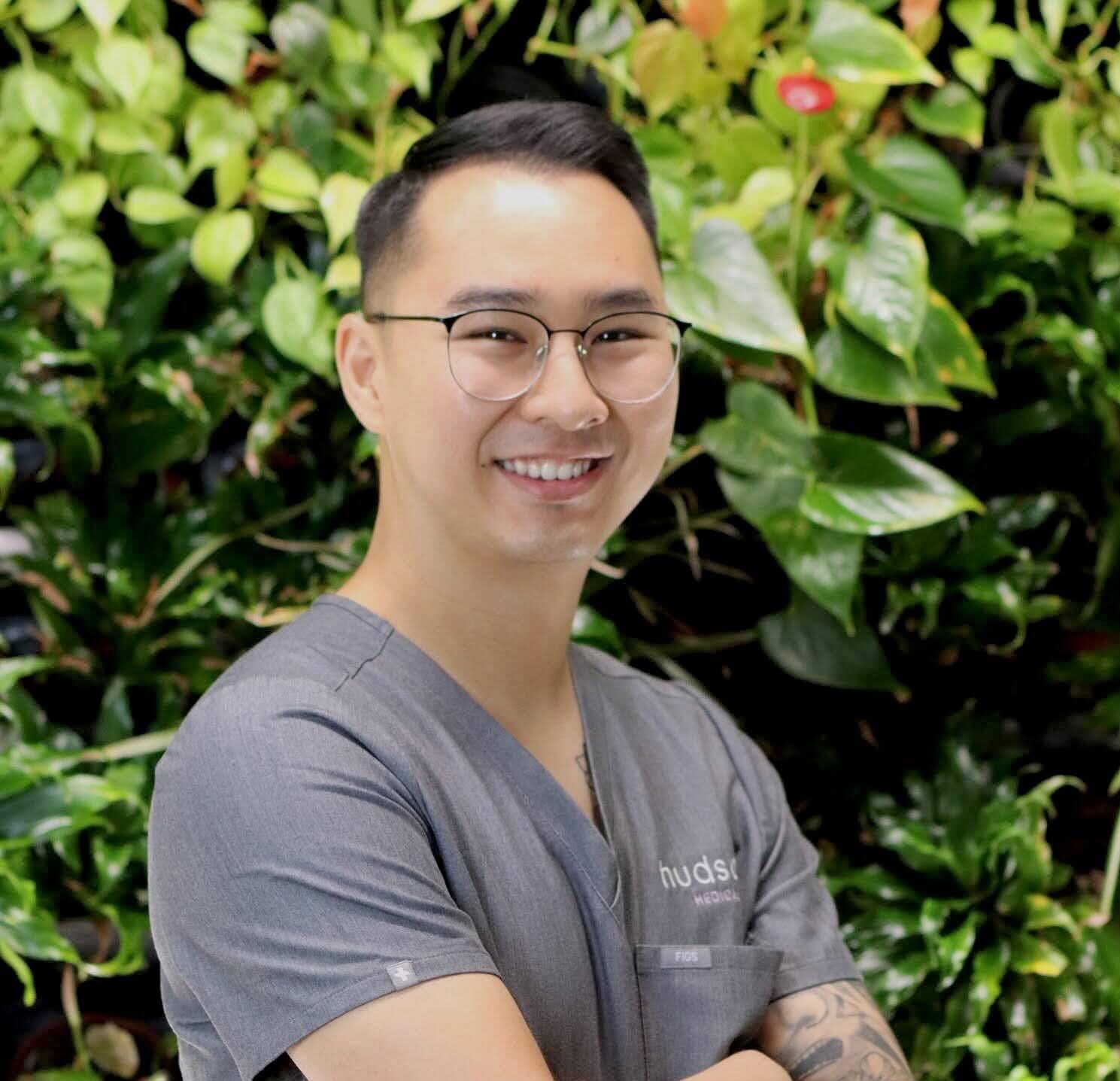 Brandon Lau portrait with green background